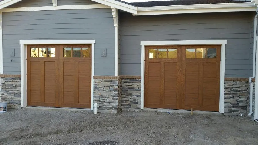 Picture of The warmth of natural wood garage doors complements the elegant stone accents of this home's facade, a testament to R & P Garage Doors' focus on quality outcomes. Copyright ©2025 Diamond Certified Resource

 - R & P Garage Doors