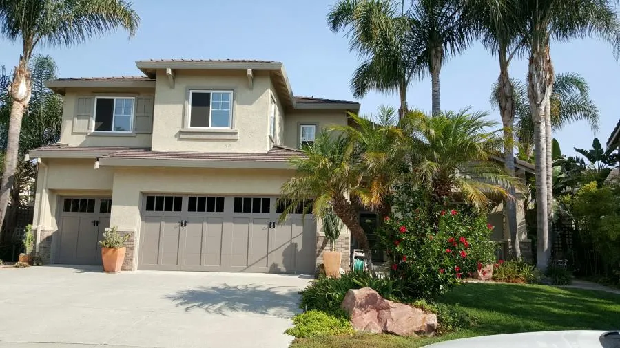 Picture of A serene neighborhood home stands with a trio of meticulously installed garage doors by R & P Garage Doors, capturing their commitment to quality outcomes. Copyright ©2025 Diamond Certified Resource

 - R & P Garage Doors