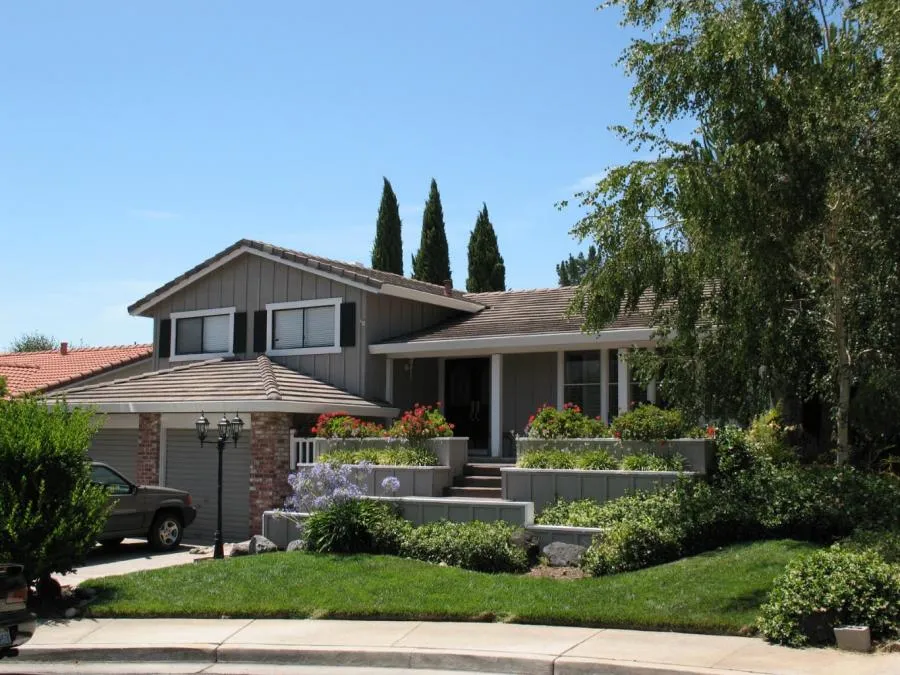 Picture of A picturesque suburban home stands gracefully with its neatly manicured lawn and vibrant flower beds, reflecting the quality outcomes Los Gatos Roofing consistently delivers. Recognized for its expertise and quality, the company ensures every project enhances the curb appeal seamlessly. Copyright ©2025 Diamond Certified Resource - Los Gatos Roofing