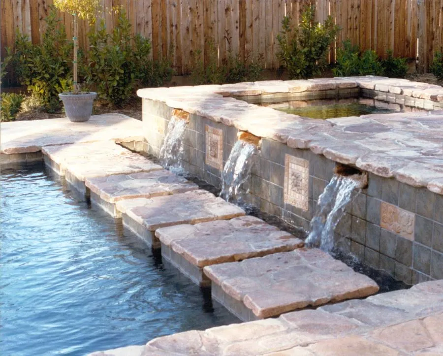 Picture of Sunlight dances on the cascading water features of this stone pool, a serene creation by Classic Pools. Noted for their high customer satisfaction, they bring tranquility to life. Copyright ©2025 Diamond Certified Resource

 - Classic Pools
