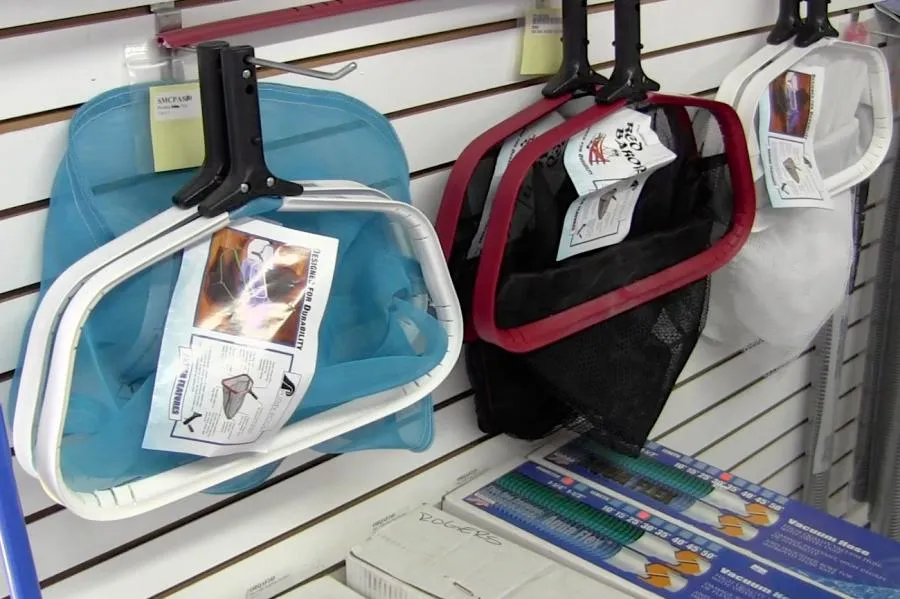 Picture of At Roger's Pool & Spa Service Inc., a selection of pool cleaning nets hangs meticulously, embodying the company's focus on quality outcomes. Each tool reflects a commitment to high customer satisfaction ratings and the seamless care provided. Copyright ©2025 Diamond Certified Resource - Roger's Pool & Spa Service Inc.