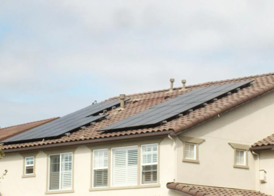 Picture of  Sunlight dances across new solar panels installed on a terracotta-tiled roof, a testament to All Seasons Roofing & Waterproofing, Inc.'s focus on quality outcomes and sustainability. Copyright ©2025 Diamond Certified Resource.

 - All Seasons Roofing & Waterproofing, Inc.