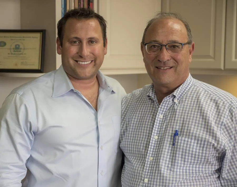 Picture of In a moment of shared success, two individuals stand proudly in a well-organized office, symbolizing the expertise and quality Closet Factory is recognized for. Copyright ©2025 Diamond Certified Resource - Closet Factory