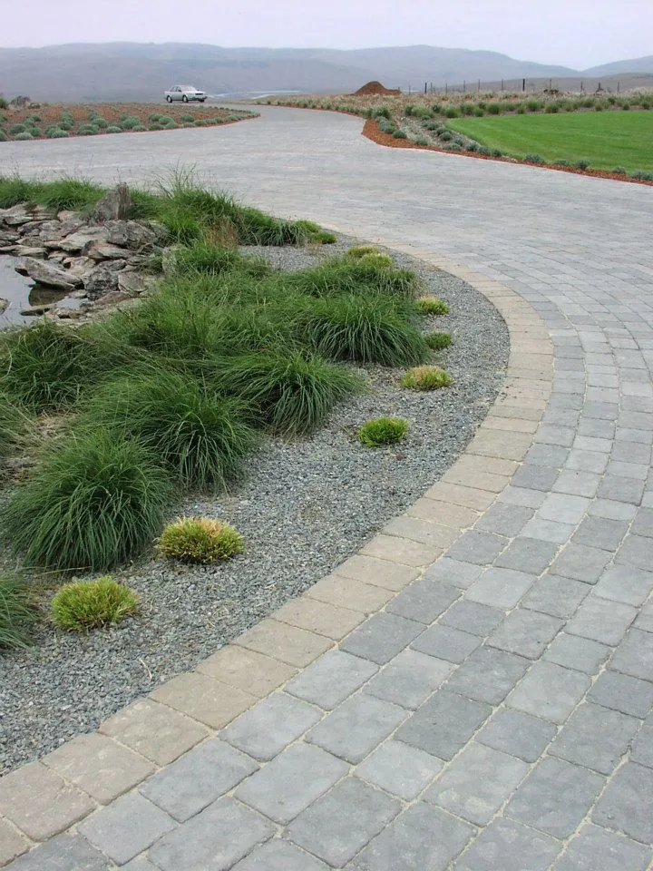 Picture of Amidst a serene landscape, the precise curves of a paved driveway reflect the meticulous craftsmanship of The Legacy Paver Group. Known for high customer satisfaction ratings, their work merges seamlessly with nature's tranquility. Copyright ©2025 Diamond Certified Resource

 - The Legacy Paver Group