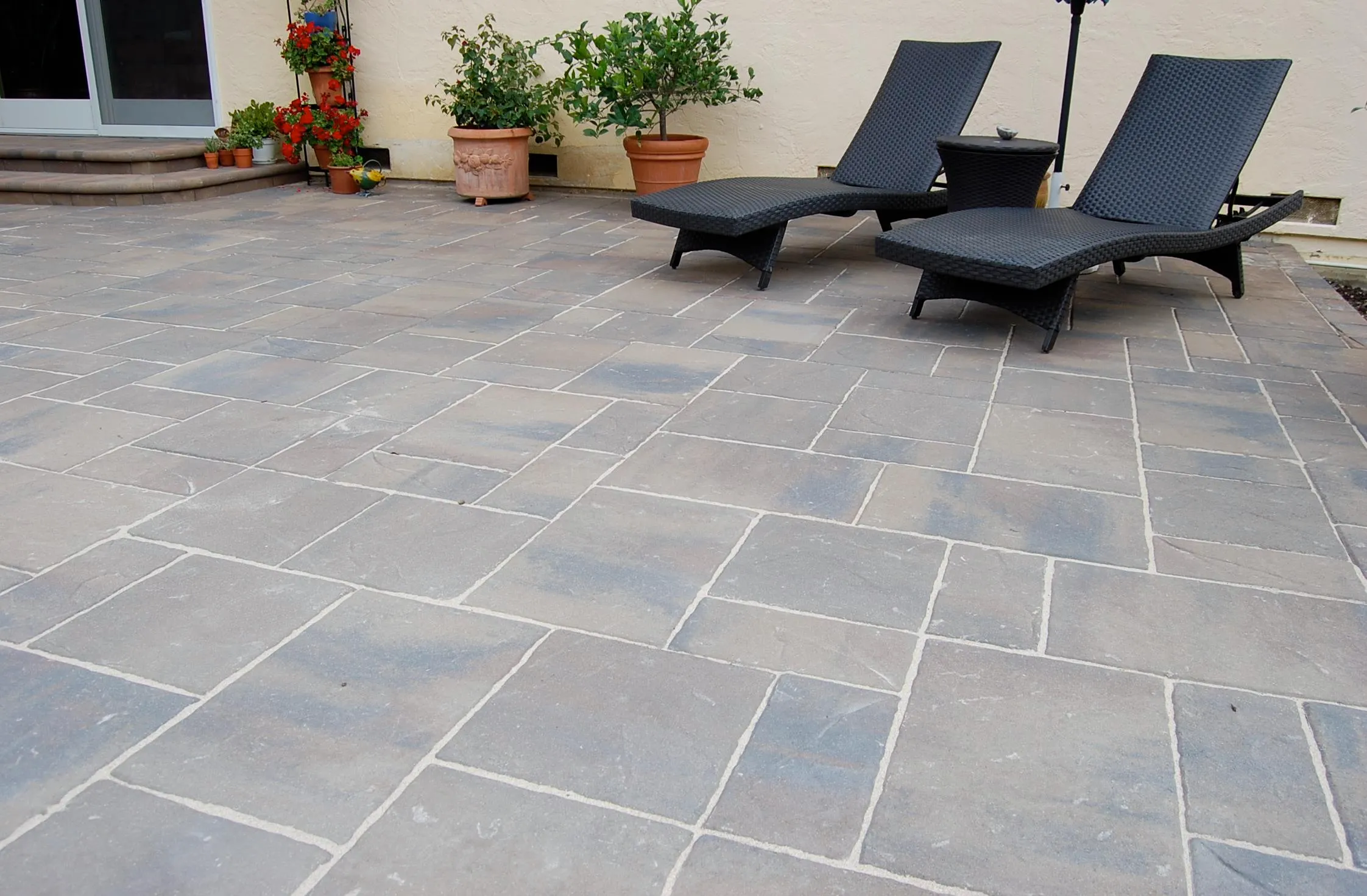 Picture of In a serene patio space, perfectly laid pavers create a harmonious setting, reflecting The Legacy Paver Group's dedication to quality outcomes. Relaxation meets craftsmanship. Copyright ©2025 Diamond Certified Resource

 - The Legacy Paver Group