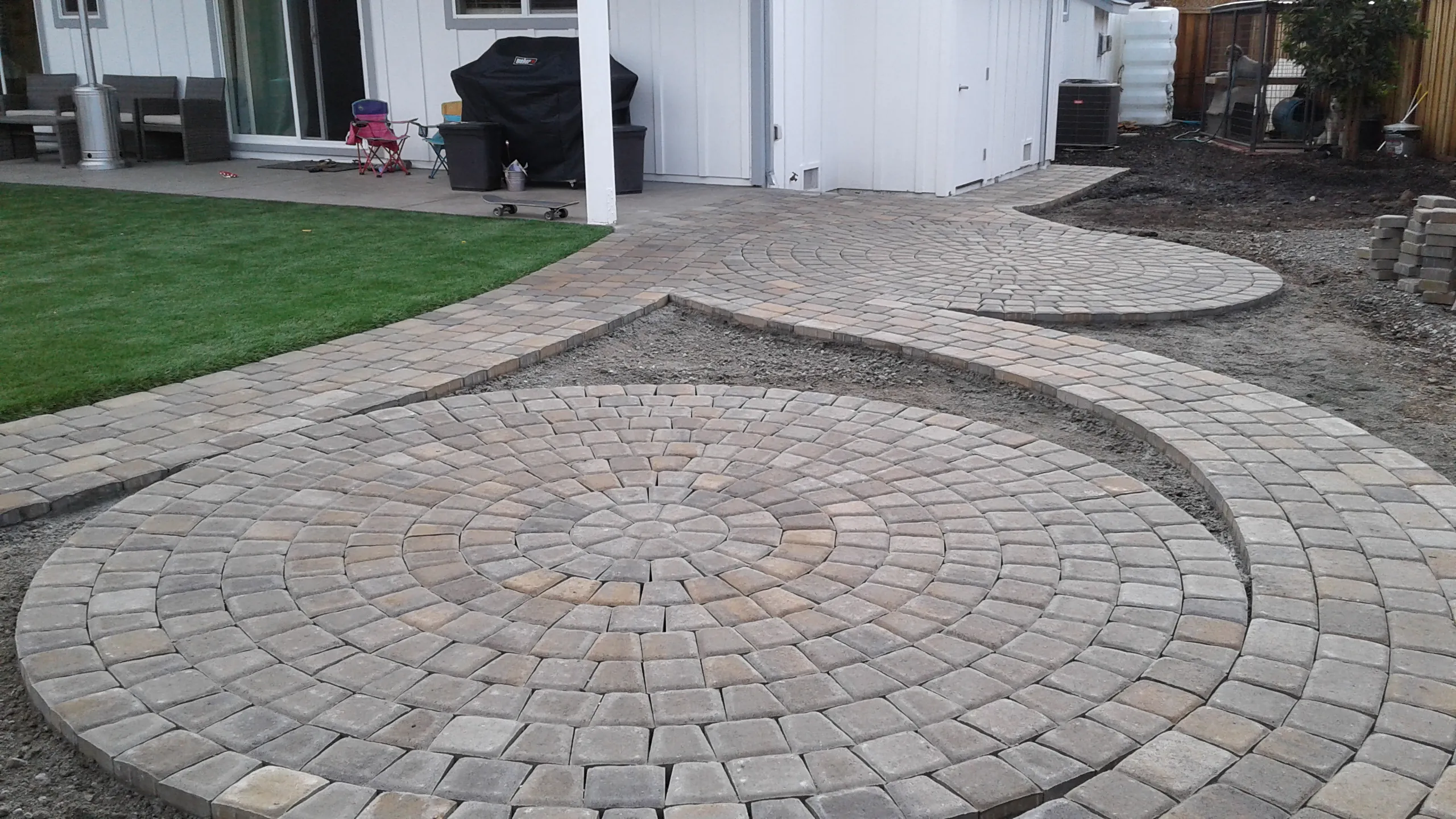 Picture of The intricate circular patterns of a newly laid stone pathway hint at skilled craftsmanship and attention to detail. The Legacy Paver Group focuses on quality outcomes, creating inviting outdoor spaces. Copyright ©2025 Diamond Certified Resource

 - The Legacy Paver Group
