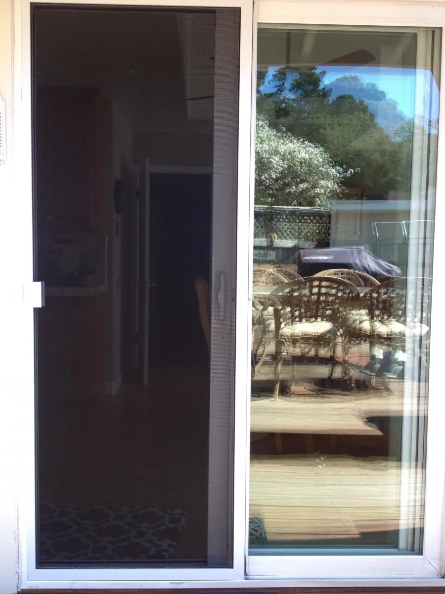 Picture of A sliding screen door opens to reveal a sunlit patio, reflecting meticulous craftsmanship. Wesco Screen Company Inc. exemplifies quality outcomes in every installation. Copyright ©2025 Diamond Certified Resource

 - Wesco Screen Company Inc.