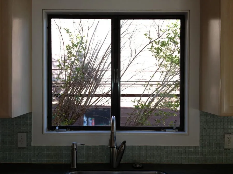 Picture of A serene view from a kitchen showcases the quality of installation by Wesco Screen Company Inc., emphasizing their focus on quality outcomes through expertly fitted window screens. The subtle greens outside blend harmoniously with the interior, reflecting their commitment to customer satisfaction. Copyright ©2025 Diamond Certified Resource

 - Wesco Screen Company Inc.