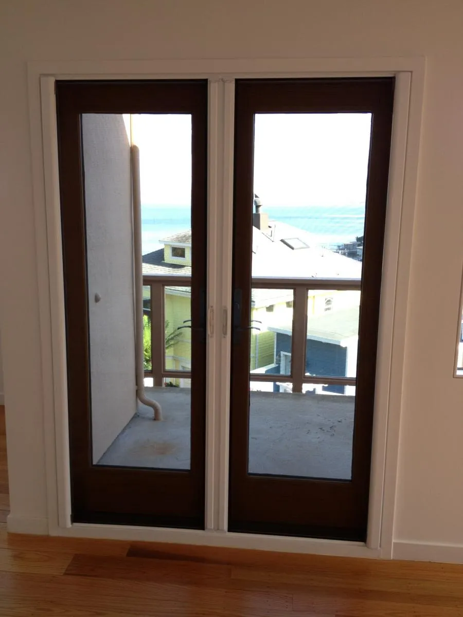 Picture of A serene view through newly installed French doors, leading to a sunlit balcony overlooking the ocean. Crafted with precision by Wesco Screen Company Inc., this installation captures their commitment to quality outcomes. Copyright ©2025 Diamond Certified Resource

 - Wesco Screen Company Inc.