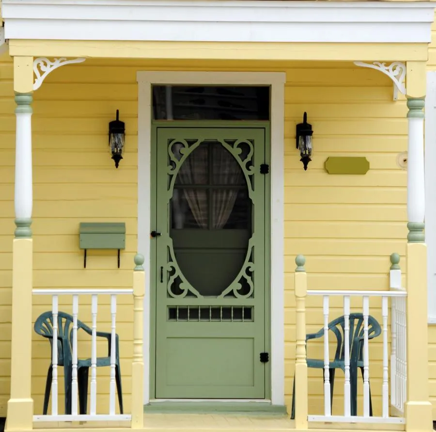 Picture of A charming yellow porch with intricate green detailing hints at Wesco Screen Company Inc.'s commitment to enhancing homes with tasteful elegance. The inviting entrance showcases the firm's top-rated quality. Copyright ©2025 Diamond Certified Resource

 - Wesco Screen Company Inc.