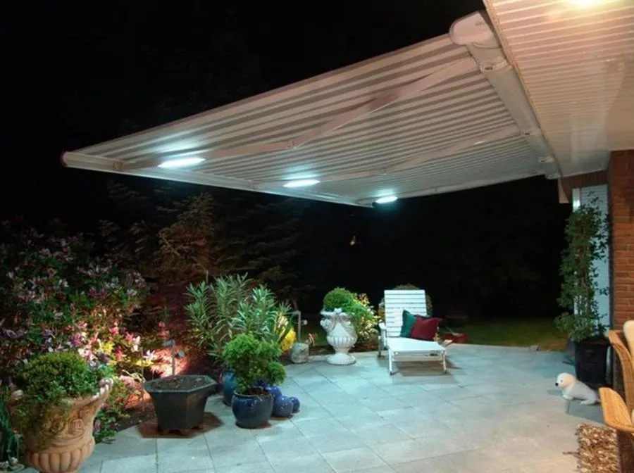 Picture of Under the glow of soft patio lights, a retractable awning by Wesco Screen Company Inc. provides shade and elegance to an evening garden setting. Known for consistently achieving a Highest in Quality rating, Wesco enhances outdoor spaces with expert craftsmanship. Copyright ©2025 Diamond Certified Resource

 - Wesco Screen Company Inc.
