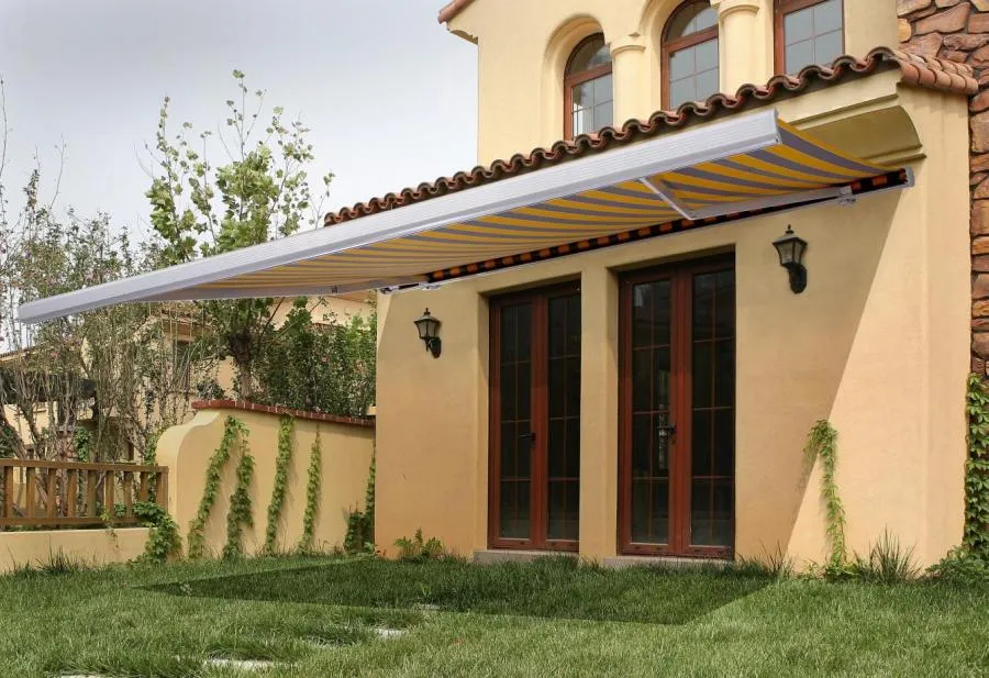 Picture of A vivid striped awning extends over a sunlit patio, offering shade and elegance to this charming home. Crafted by Wesco Screen Company Inc., known for its expertise and quality. Copyright ©2025 Diamond Certified Resource - Wesco Screen Company Inc.