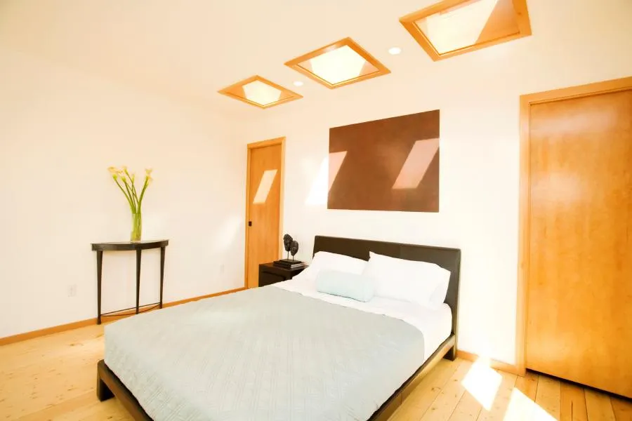 Picture of In this serene bedroom designed by Wesco Screen Company Inc., natural light filters through stylish skylights, enhancing the minimalist decor. Known for high customer satisfaction ratings, Wesco ensures quality outcomes that transform spaces into tranquil retreats. Copyright ©2025 Diamond Certified Resource

 - Wesco Screen Company Inc.