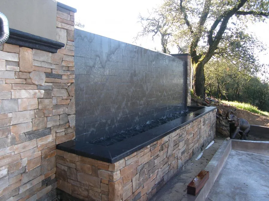 Picture of A serene stone water feature crafted by Classic Pools blends seamlessly into the natural surroundings, showcasing their focus on quality outcomes. Achieving a tranquil retreat, Classic Pools exemplifies expertise and quality in outdoor design. Copyright ©2025 Diamond Certified Resource - Classic Pools