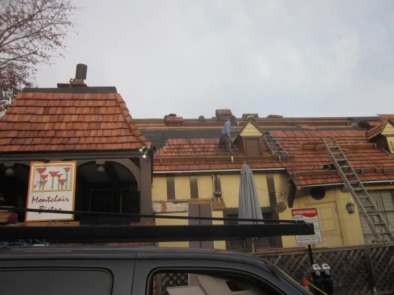 Picture of A skilled worker from Ben's Roofing, Inc. carefully installs new tiles on a charming, vintage-style rooftop, ensuring durability and a classic look. Recognized for their expertise and quality, the company consistently achieves the highest in quality ratings. Copyright ©2025 Diamond Certified Resource. - Ben's Roofing, Inc.