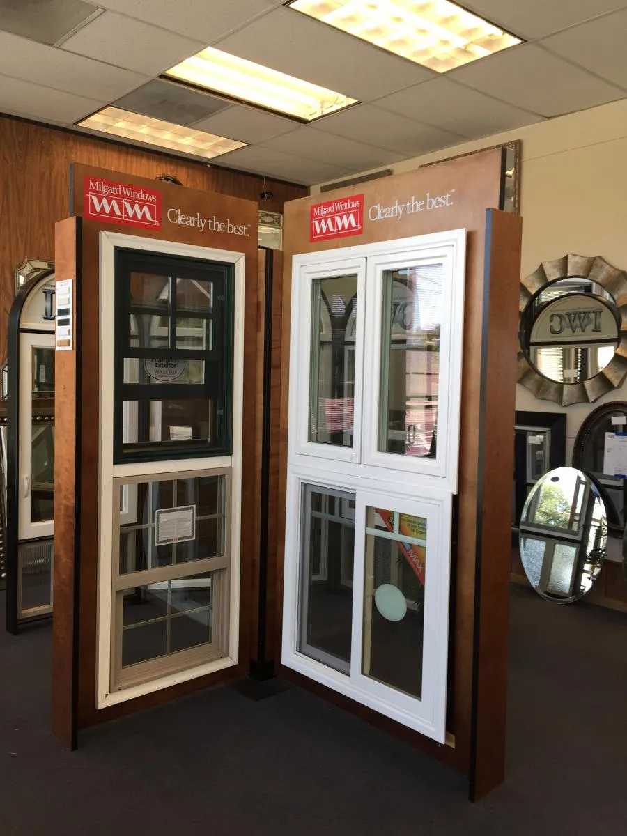  Showroom display with Milgard Windows labeled "Clearly the best" featuring two types of window designs in a well-lit interior setting.