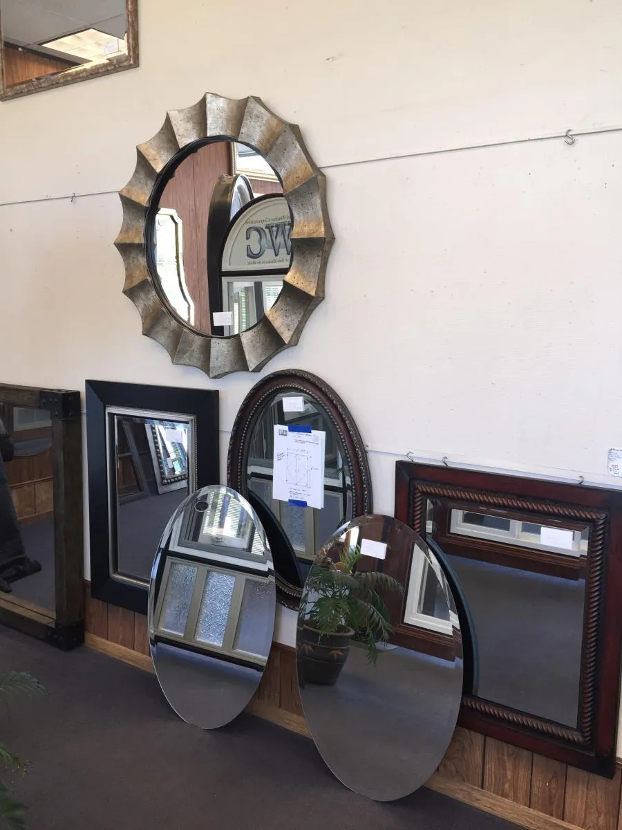 Picture of In a display of craftsmanship, a unique sunburst mirror stands out among various framed reflections, hinting at the artistry that Kapple Drywall brings to interior spaces. This attention to detail is part of what earned the company a Diamond Certified rating, showcasing their commitment to quality outcomes. Copyright ©2025 Diamond Certified Resource - Kapple Drywall