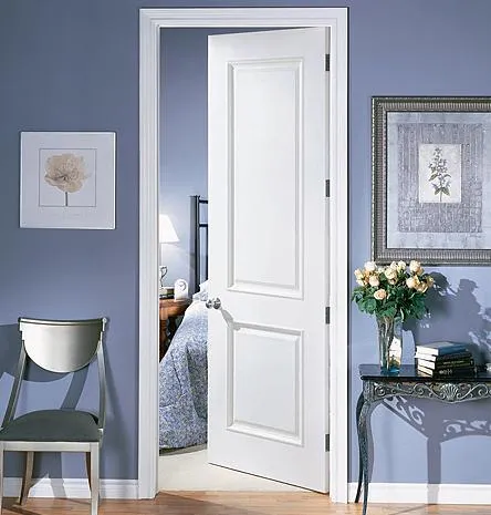 Picture of A pristine white door stands partially open, inviting a glimpse into the tranquil bedroom beyond. The scene is enhanced by Quality Windows & Doors, Inc., recognized for its expertise and quality. Copyright ©2025 Diamond Certified Resource. - Quality Windows & Doors, Inc.
