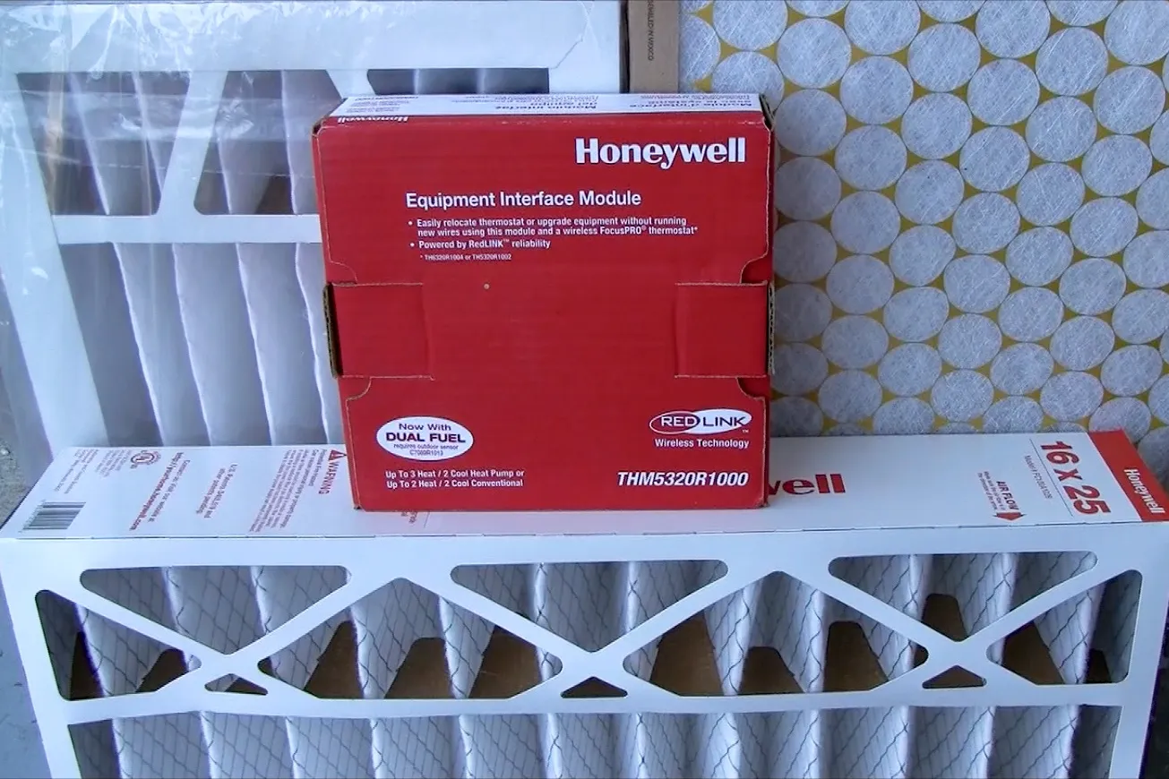 Honeywell equipment interface module and air filters displayed against a patterned background. Honeywell equipment interface module and air filters displayed against a patterned background.