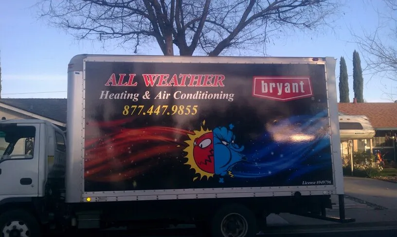 A truck with All Weather Heating & Air Conditioning Inc. branding, parked on a suburban street, featuring company contact details and logo.