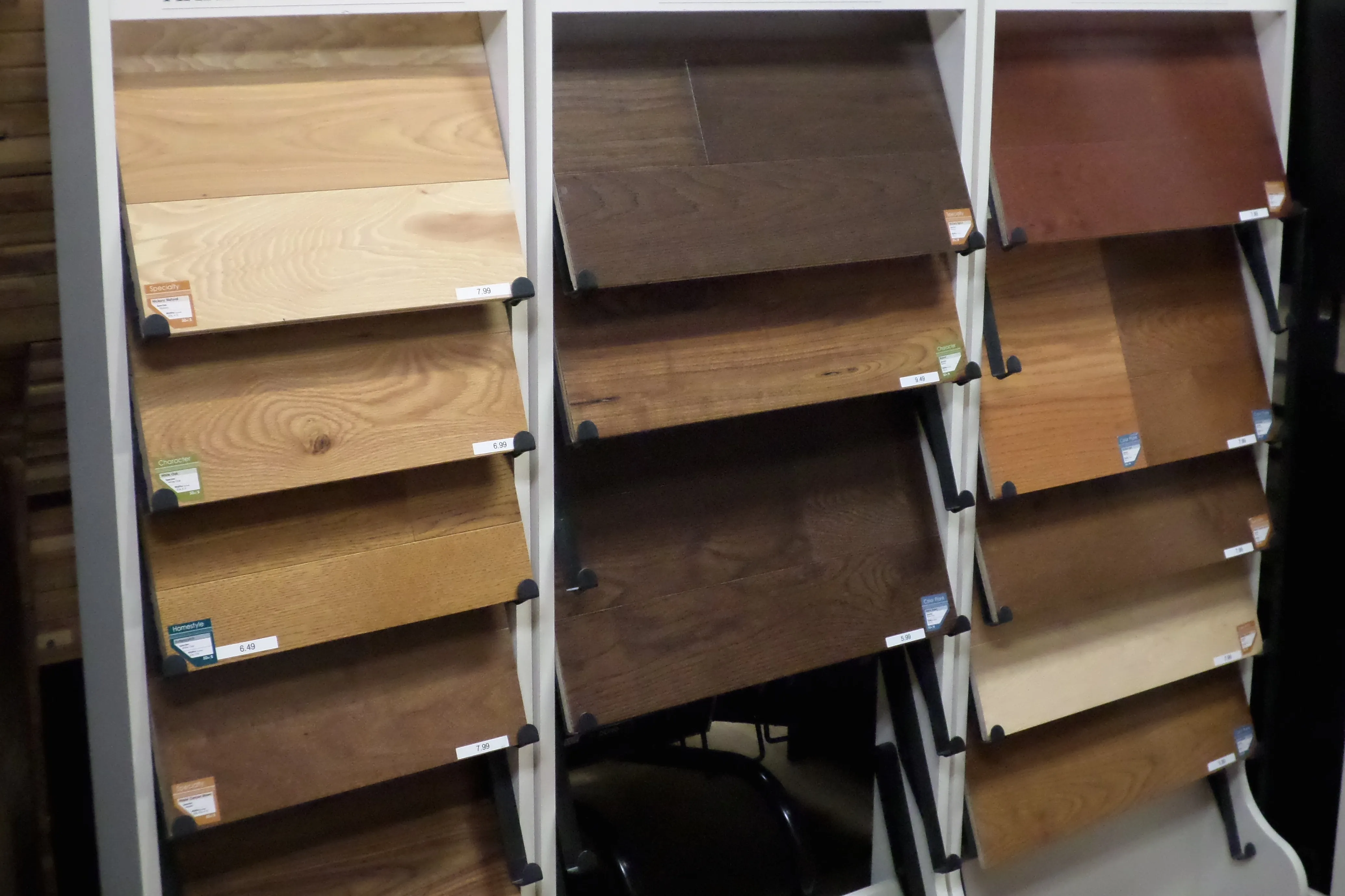 Display of hardwood samples in various shades and grains, arranged on vertical racks. Display of hardwood samples in various shades and grains, arranged on vertical racks.