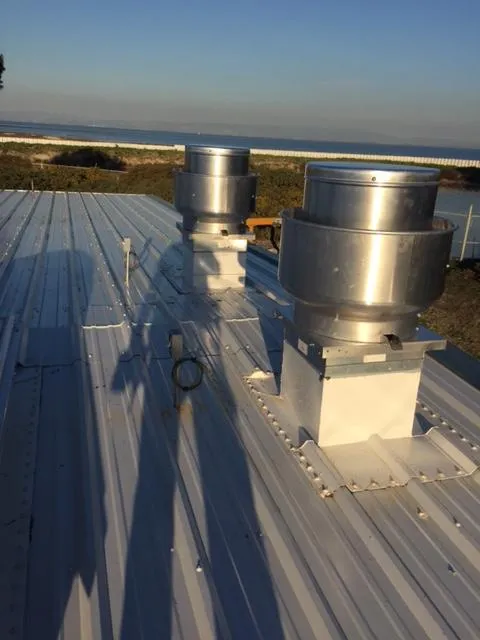 Picture of The afternoon sun casts long shadows across the rooftop, highlighting the precision installation by Degree HVAC, Inc. Their focus on quality outcomes ensures optimal ventilation performance. Copyright ©2025 Diamond Certified Resource - Degree HVAC, Inc.