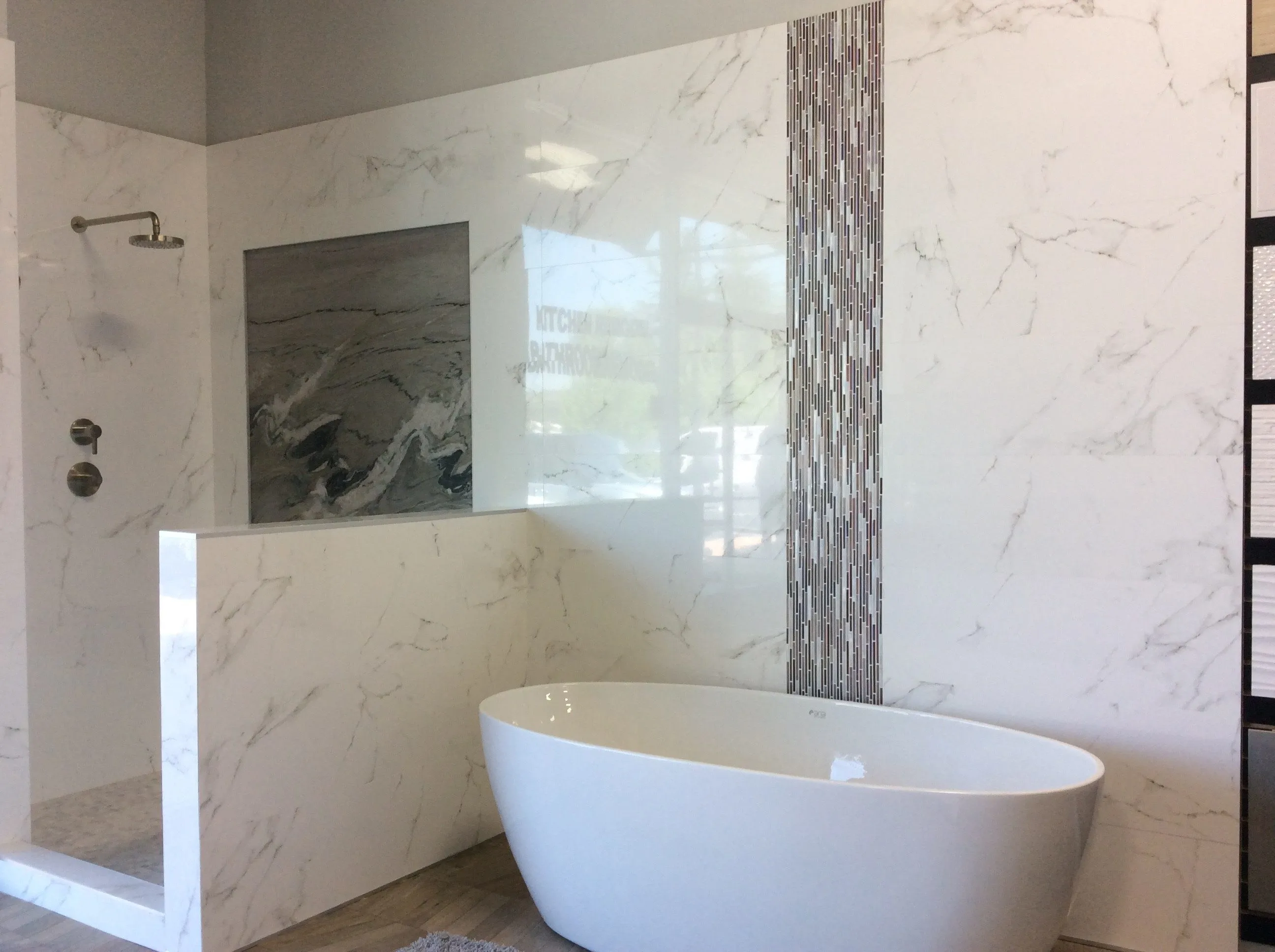 Picture of In this elegant bathroom display, the understated luxury of marble walls meets the sleek design of a modern bathtubâ€”an embodiment of Today's Kitchen & Bath's focus on quality outcomes. Copyright ©2025 Diamond Certified Resource

 - Today's Kitchen & Bath