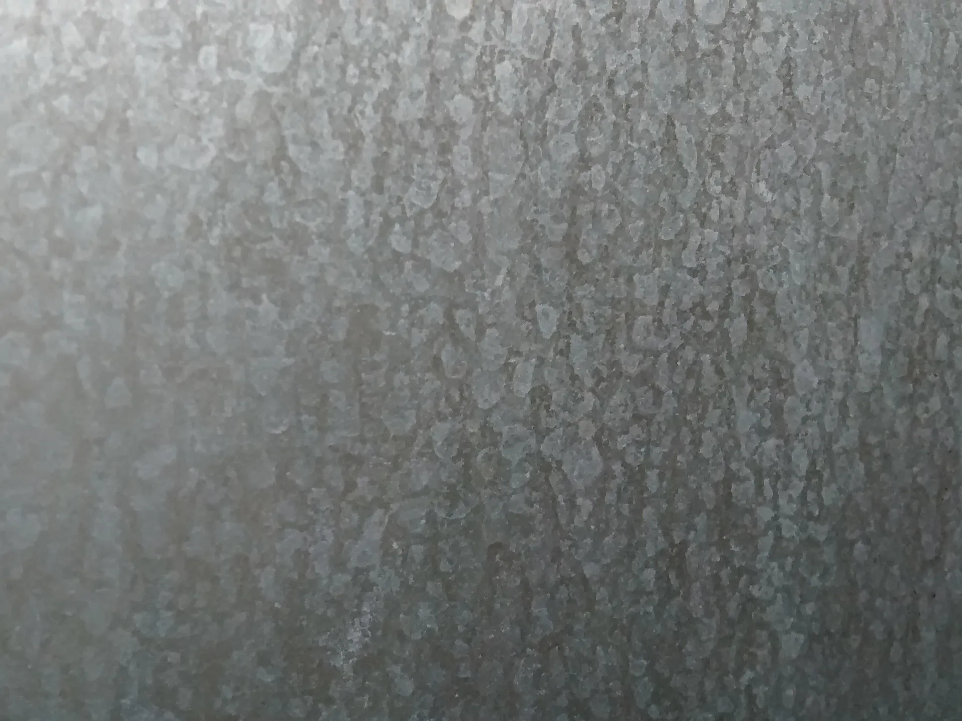 Close-up view of a textured metal surface displaying a pattern of small, uneven marks and a matte finish. Close-up view of a textured metal surface displaying a pattern of small, uneven marks and a matte finish.