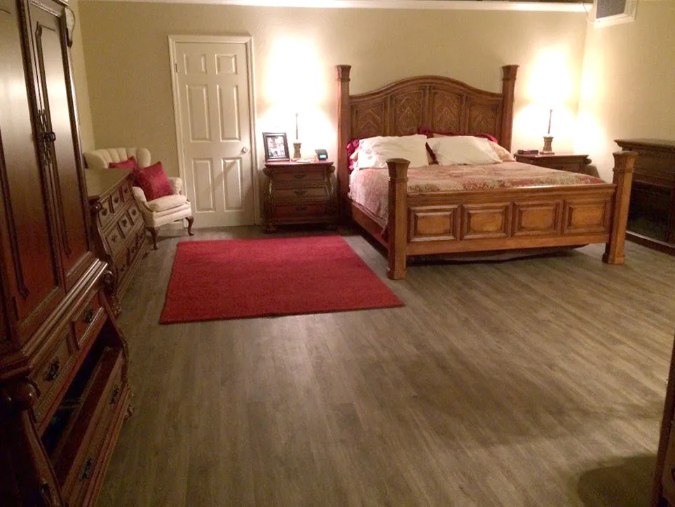 Picture of In a warmly lit bedroom, the rich wooden furniture complements the deep red accents, all resting on expertly installed flooring by Abbey Carpets by Fashion Floors, known for their helpful expertise and quality. Copyright ©2025 Diamond Certified Resource

 - Abbey Carpets by Fashion Floors