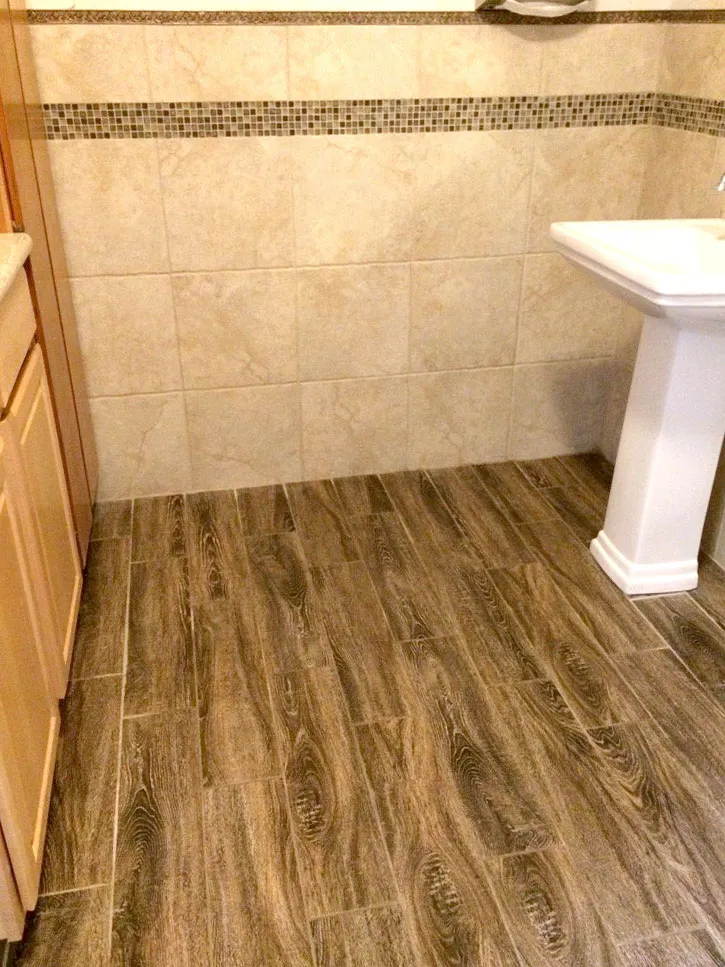 Picture of The elegant blend of wood-patterned tiles and intricate wall detailing captures Abbey Carpets by Fashion Floorsâ€™ commitment to quality outcomes. Experience the transformation that has earned them Diamond Certified recognition. Copyright ©2025 Diamond Certified Resource

 - Abbey Carpets by Fashion Floors