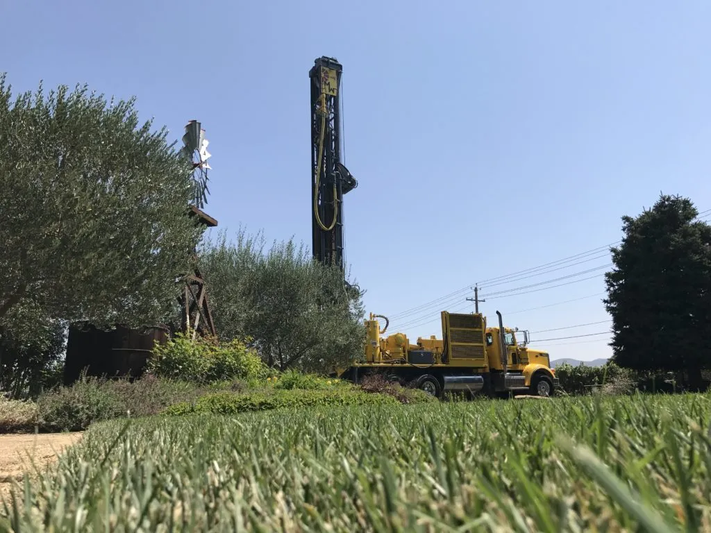 Picture of A vibrant yellow drilling truck stands ready at a well site, surrounded by lush greenery and clear skies, exemplifying McLean & Williams, Inc.'s focus on quality outcomes. Copyright ©2025 Diamond Certified Resource

 - McLean & Williams, Inc.