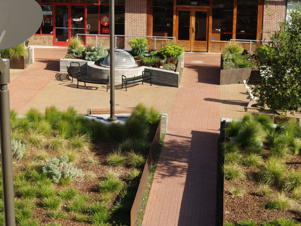 Picture of A meticulously crafted walkway meanders through lush greenery, leading to a welcoming plaza. The Legacy Paver Groupâ€™s dedication to quality outcomes is evident in every detail. Copyright ©2025 Diamond Certified Resource

 - The Legacy Paver Group