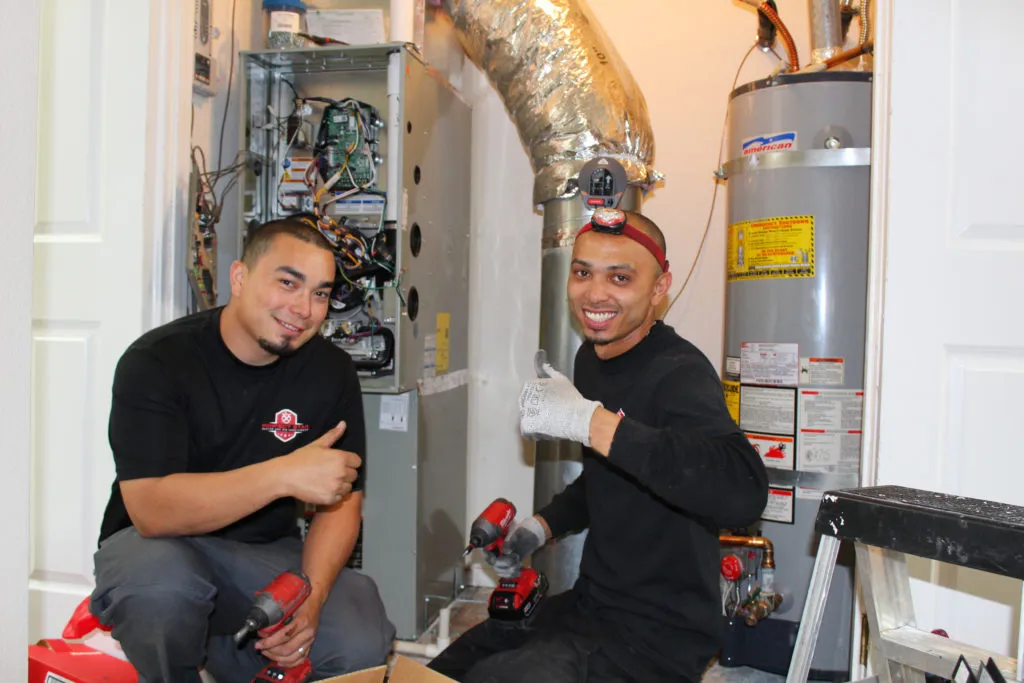 Picture of Lead Install Technicians David Mendoza (L) and Gilbert Caceres install a new HVAC system in Blackhawk. - Perfect Star Heating, Cooling, & Electrical
