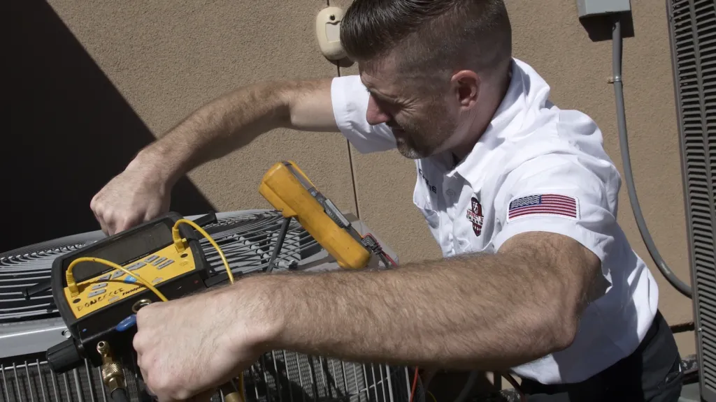 Picture of Owner Chris Donzelli services a client's air conditioning unit in Brentwood. - Perfect Star Heating, Cooling, & Electrical