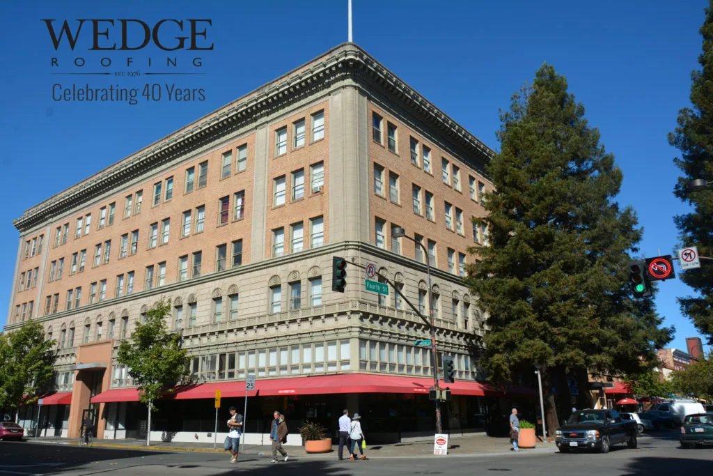 Picture of A historic building on a bustling corner stands as a testament to Wedge Roofing's commitment to quality outcomes. Celebrating 40 years of excellence, the company consistently achieves the highest ratings in quality. Copyright ©2025 Diamond Certified Resource

 - Wedge Roofing