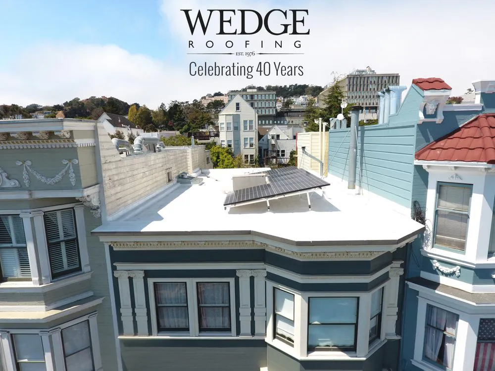 Picture of Under the clear sky, Wedge Roofing showcases a pristine white rooftop adorned with solar panels, highlighting their focus on quality outcomes. Celebrating 40 years of service, they continue to impress with their craftsmanship. Copyright ©2025 Diamond Certified Resource - Wedge Roofing