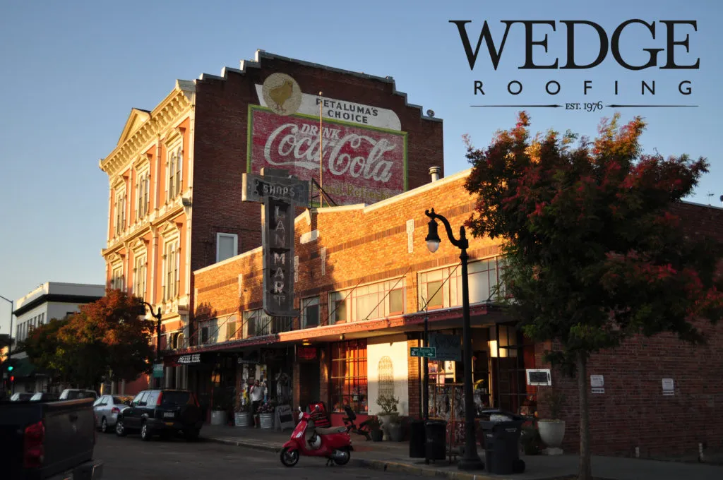 Picture of In the warm glow of sunset, a historic brick building stands resilient with its vintage Coca-Cola mural. Wedge Roofing's commitment to quality outcomes ensures structures like this remain durable and timeless. Copyright ©2025 Diamond Certified Resource

 - Wedge Roofing