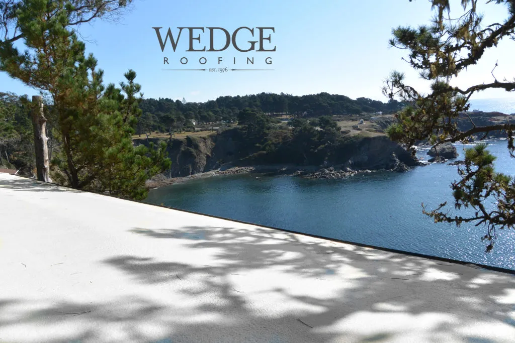 Picture of A pristine white rooftop overlooks a serene coastal view, embodying Wedge Roofing's dedication to quality outcomes. The tranquil setting highlights their top-rated expertise. Copyright ©2025 Diamond Certified Resource - Wedge Roofing