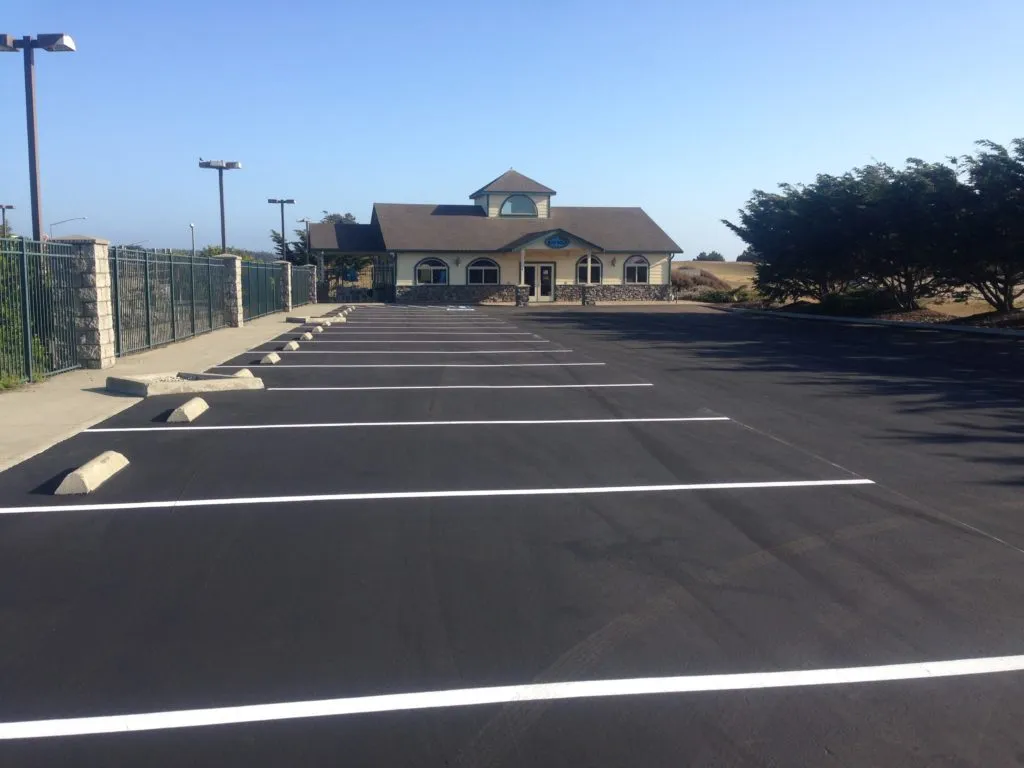 Picture of A freshly paved, pristine parking lot leads to a charming office building, showcasing Jackson's Paving & Equipment Rentals, Inc.’s commitment to quality outcomes. The company’s expert craftsmanship is recognized for achieving a Highest in Quality rating, evident in the seamless asphalt finish. Copyright ©2025 Diamond Certified Resource. - Jackson's Paving & Equipment Rentals, Inc.