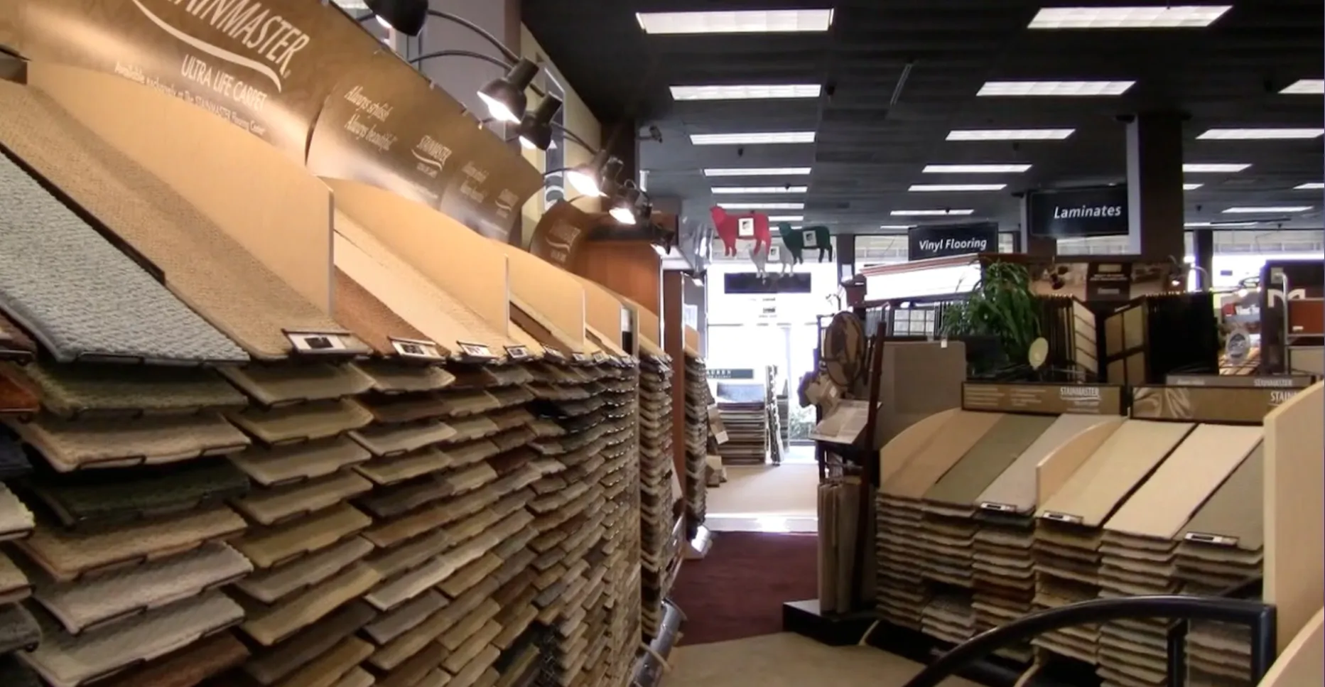 Picture of Shelves of carpet samples bask in warm lighting at City Carpets, showcasing a diverse range of textures and hues. This inviting display reflects the companyâ€™s focus on quality outcomes, resonating with customers. Copyright ©2025 Diamond Certified Resource

 - City Carpets