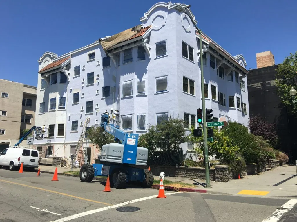 Picture of Workers from S & S Painting and Coatings, Inc. meticulously restore a historic building’s facade, embodying the company’s focus on quality outcomes. Traffic cones guide pedestrians safely around the work zone. Copyright ©2025 Diamond Certified Resource. - S & S Painting and Coatings, Inc.