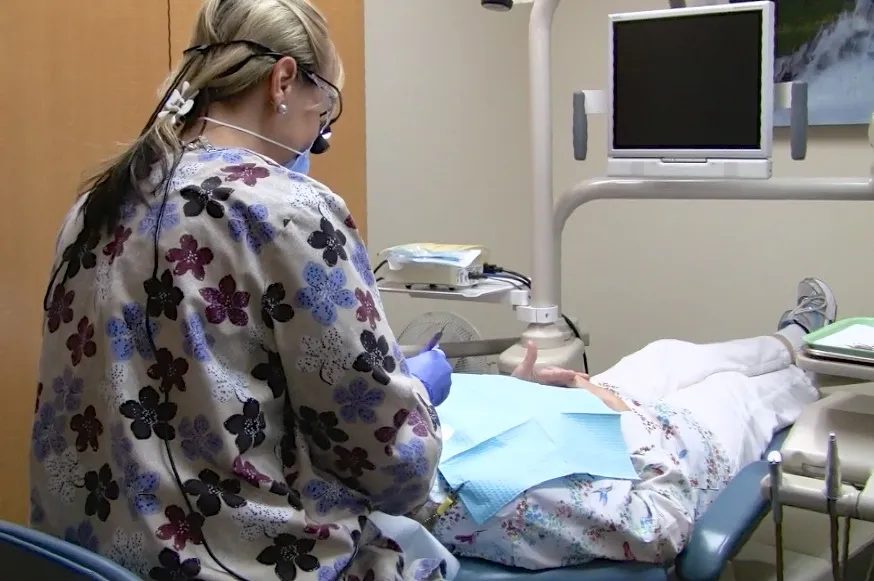 Picture of A dental professional at William M. Schneider, D.D.S. attentively cares for a patient, embodying the practice's focus on quality outcomes. The serene setting underscores the calm expertise patients trust. Copyright ©2025 Diamond Certified Resource

 - William M. Schneider, D.D.S.