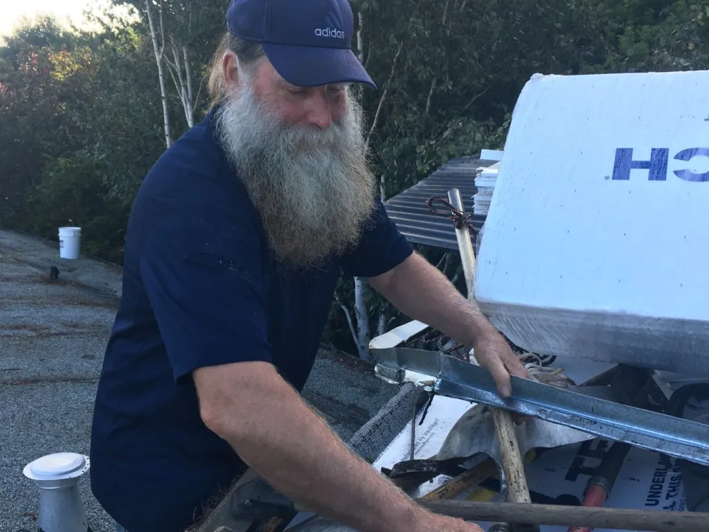 Picture of  A dedicated craftsman from Capstone Roofing, Inc. prepares materials on a rooftop, embodying the company’s focus on quality outcomes and expert service. Copyright ©2025 Diamond Certified Resource.

 - Capstone Roofing, Inc.