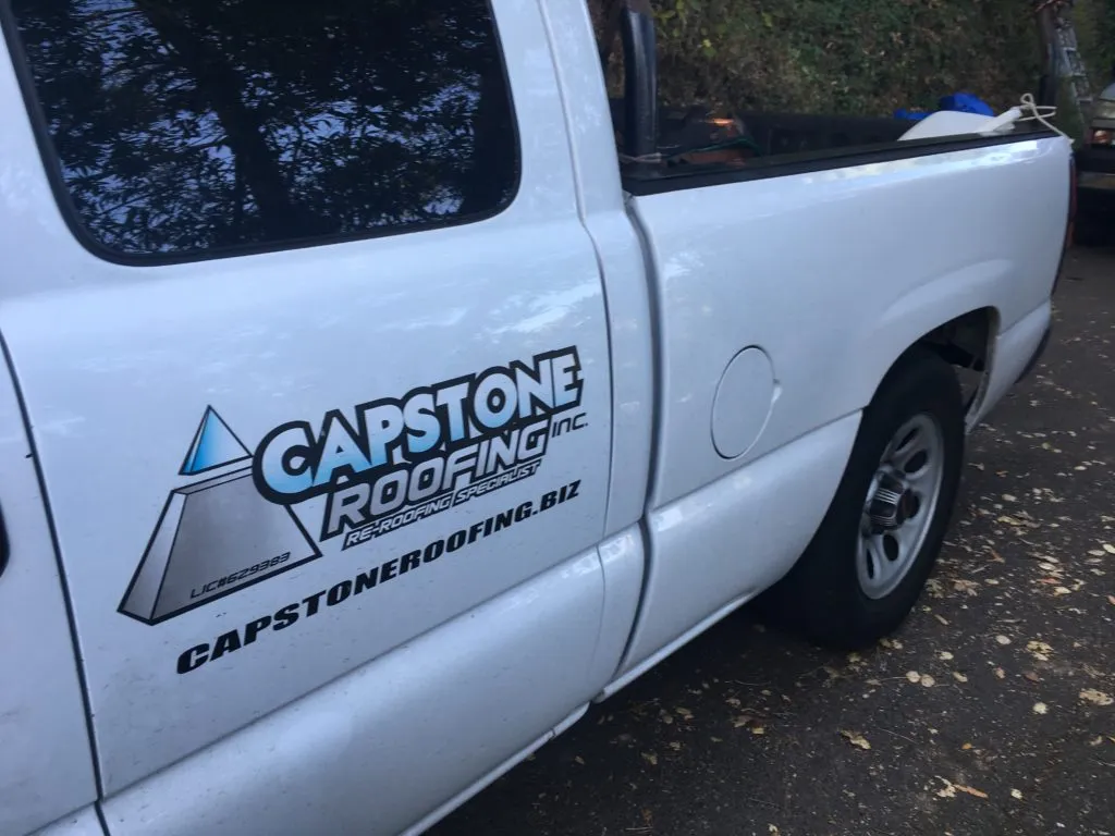 Picture of A Capstone Roofing, Inc. service truck stands ready amid a wooded backdrop, symbolizing the company's dedication to quality outcomes in every project. Recognized for expertise and quality, Capstone Roofing, Inc. is committed to top-rated performance. Copyright ©2025 Diamond Certified Resource. - Capstone Roofing, Inc.