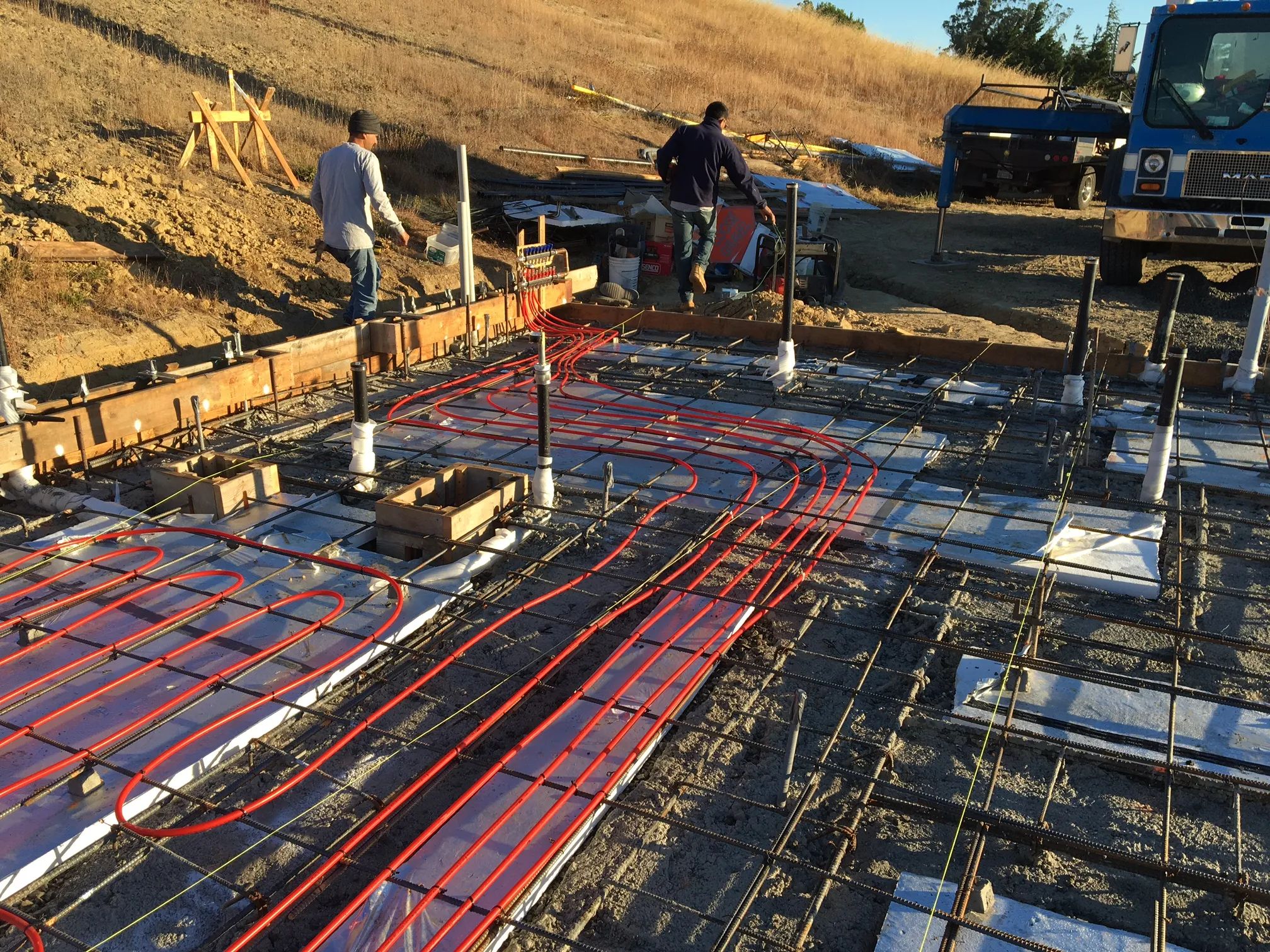 Picture of As the sun sets, Evenich Construction, Inc. meticulously prepares a foundation with embedded radiant heating pipes, showcasing a focus on quality outcomes. Their dedication to innovative solutions is a testament to their top-rated quality. Copyright ©2025 Diamond Certified Resource. - Evenich Construction, Inc.