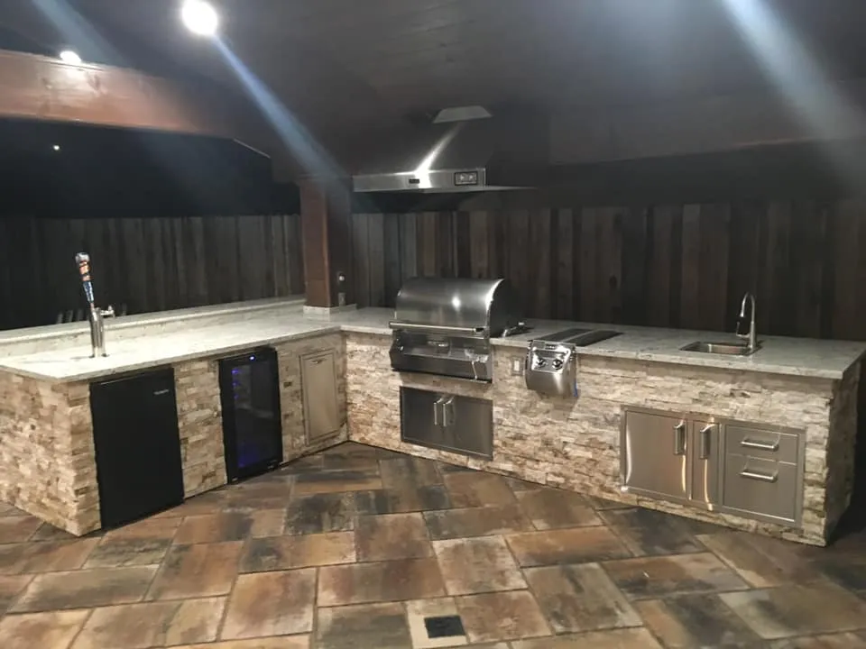 Picture of  An elegant outdoor kitchen with polished stone countertops and stainless steel appliances embodies the craftsmanship of Mr. Pavers Contractor Services, Inc., renowned for their high customer satisfaction ratings. Copyright ©2025 Diamond Certified Resource.

 - Mr. Pavers Contractor Services, Inc.