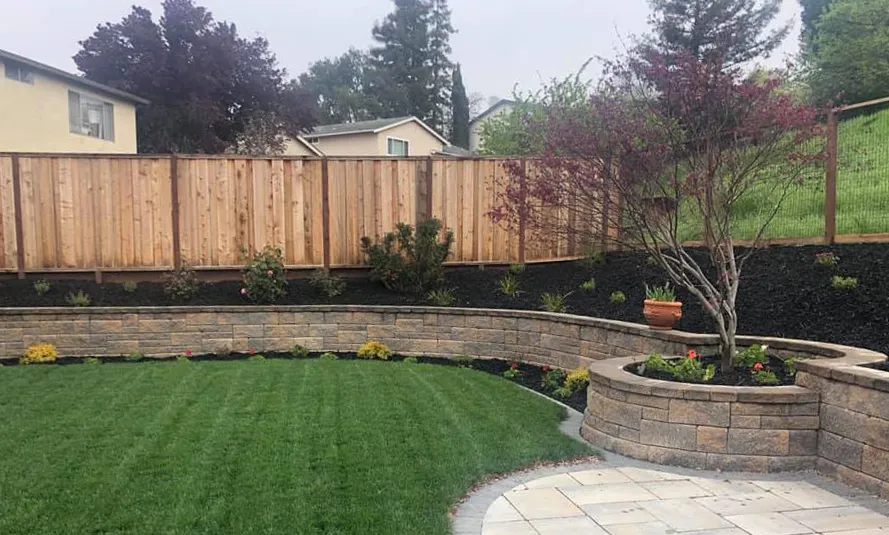 Picture of  A beautifully landscaped garden with a stone retaining wall and neatly planted flowers showcases the meticulous craftsmanship of Mr. Pavers Contractor Services, Inc., recognized for its expertise and quality. Copyright ©2025 Diamond Certified Resource.

 - Mr. Pavers Contractor Services, Inc.