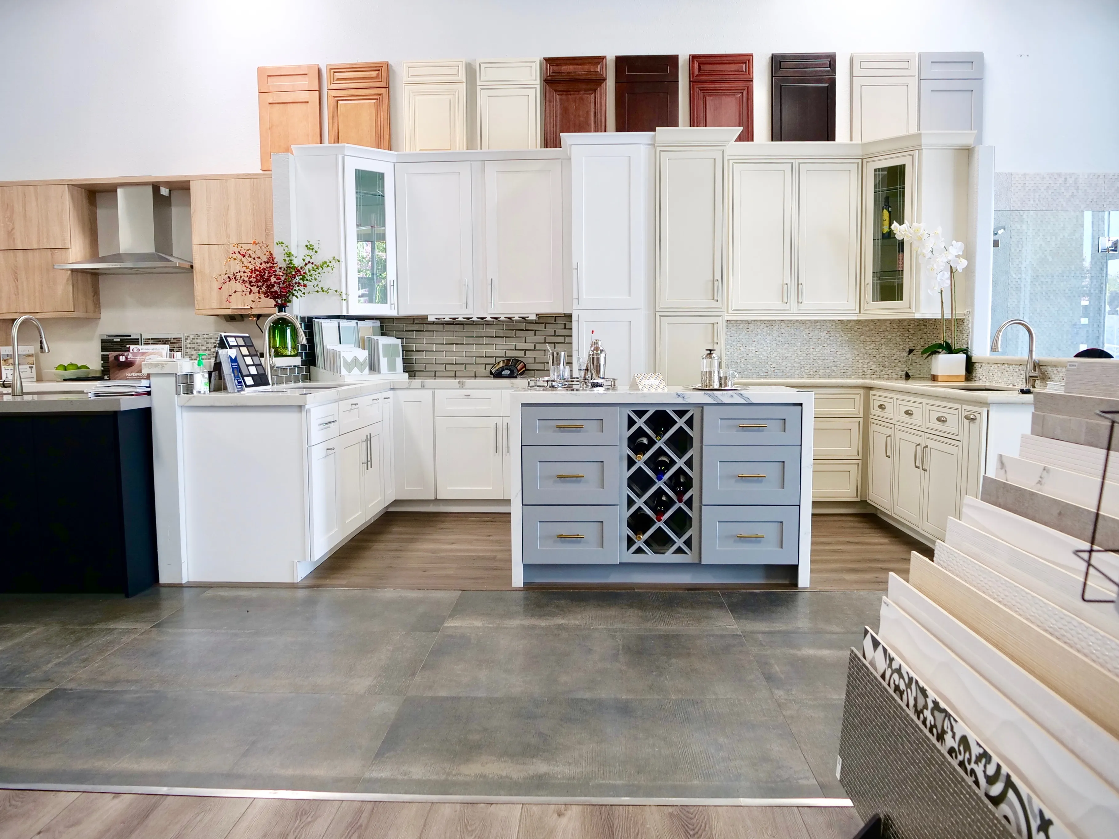 Picture of In the serene display of Today's Kitchen & Bath, a soft blue island with a wine rack invites attention amidst the elegant cabinetry. Recognized for expertise and quality, the company crafts spaces of both form and function. Copyright ©2025 Diamond Certified Resource

 - Today's Kitchen & Bath