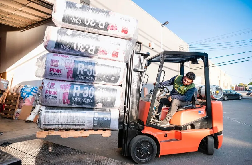 Picture of A worker expertly maneuvers a forklift laden with insulation materials, embodying Alley Cat's commitment to quality outcomes. Recognized for expertise and quality, they ensure every project starts with precision. Copyright ©2025 Diamond Certified Resource

 - Alley Cat