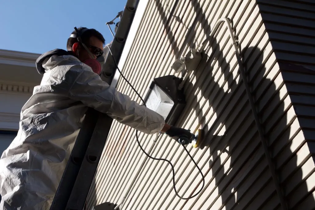 Picture of  A dedicated worker from Stanford Painting, Inc. delicately sands the siding of a house, showcasing the company’s focus on quality outcomes. This attention to detail reflects their high customer satisfaction ratings. Copyright ©2025 Diamond Certified Resource.

 - Stanford Painting, Inc.